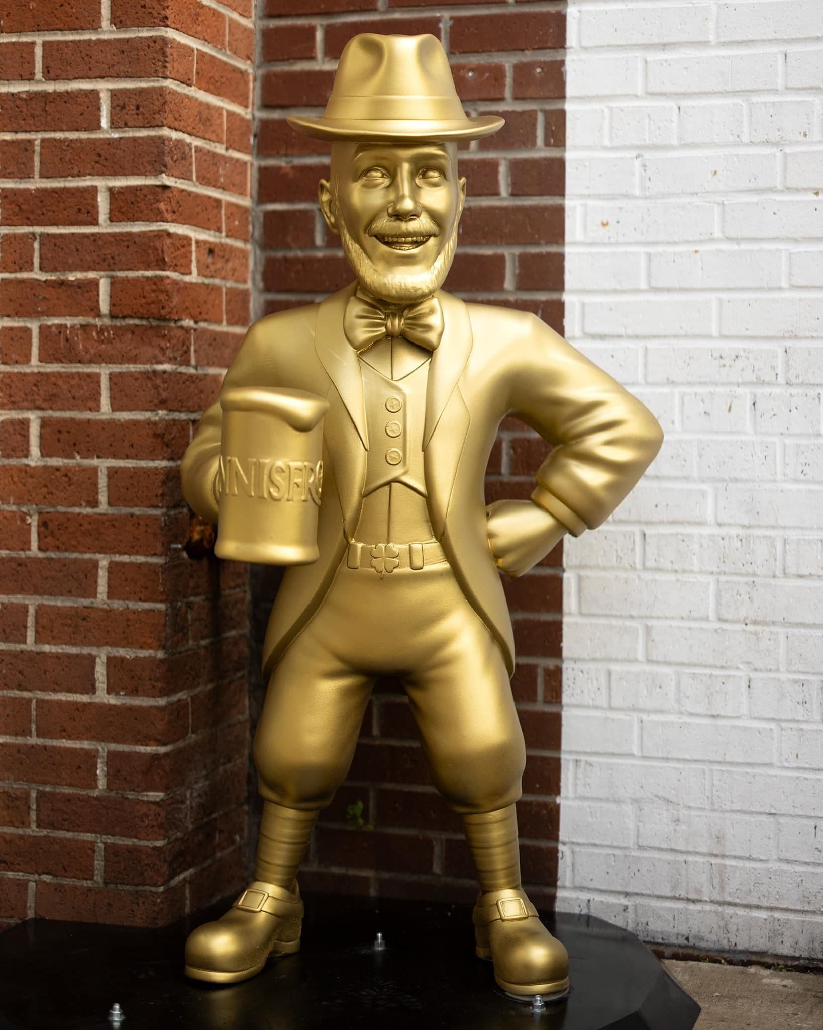 The Innisfree leprechaun cheering inside the pub